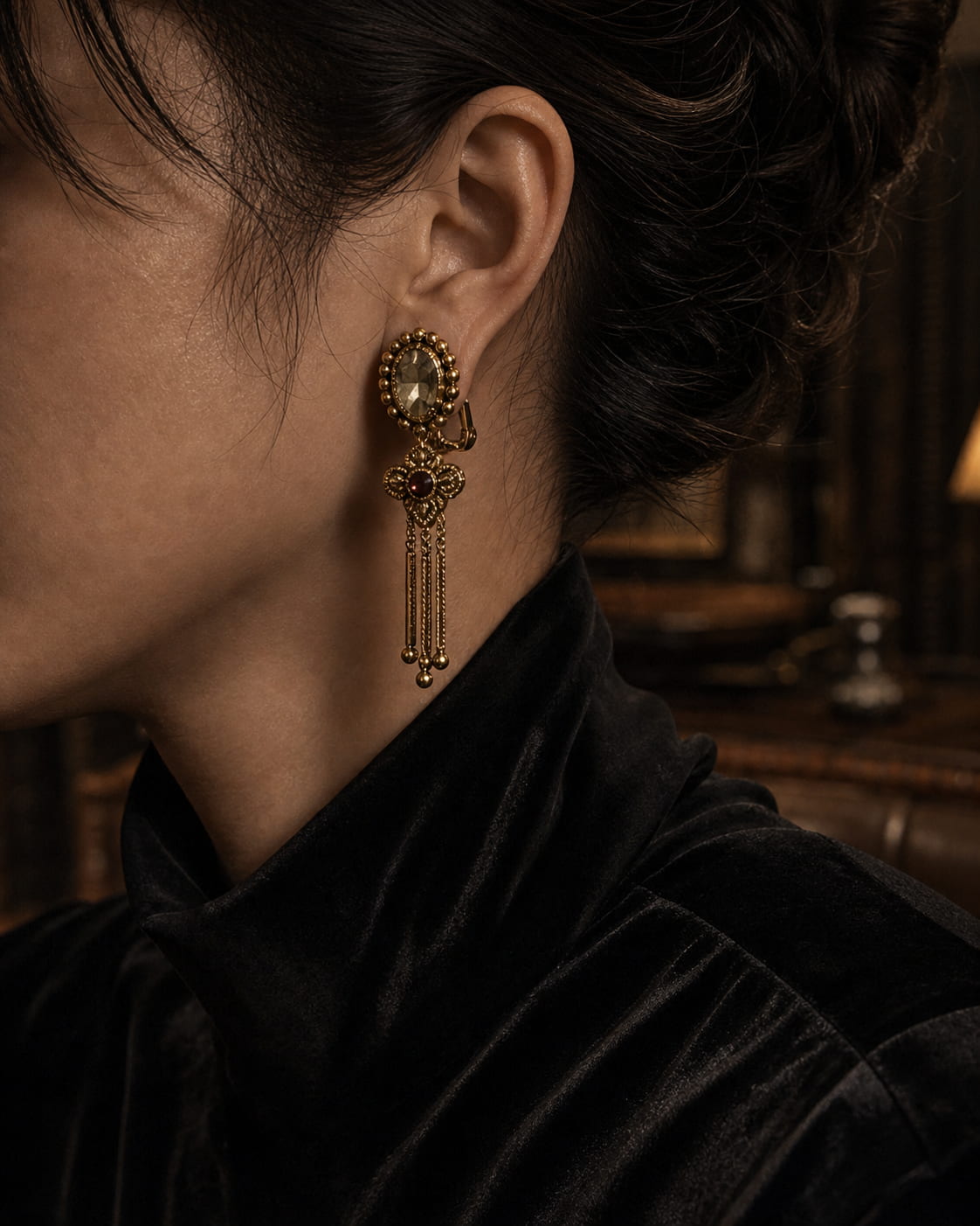 Vintage-inspired gold clip-on statement earrings styled with black velvet