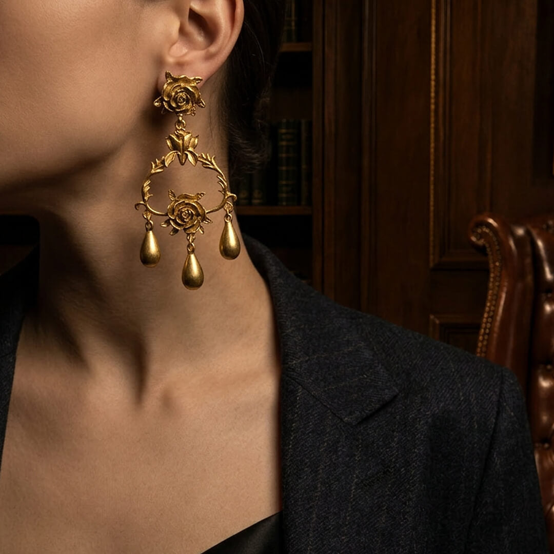Styling 1980s runway-inspired bold gold rose dangle earrings with a tailored blazer.