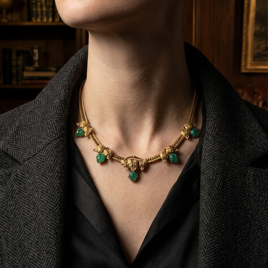 Styling a 1980s runway-inspired gold leaf statement necklace with a tailored grey blazer for an Old Money aesthetic.
