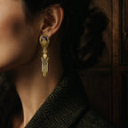 Styling 1980s runway-inspired geometric gold dangle earrings with a tailored blazer.