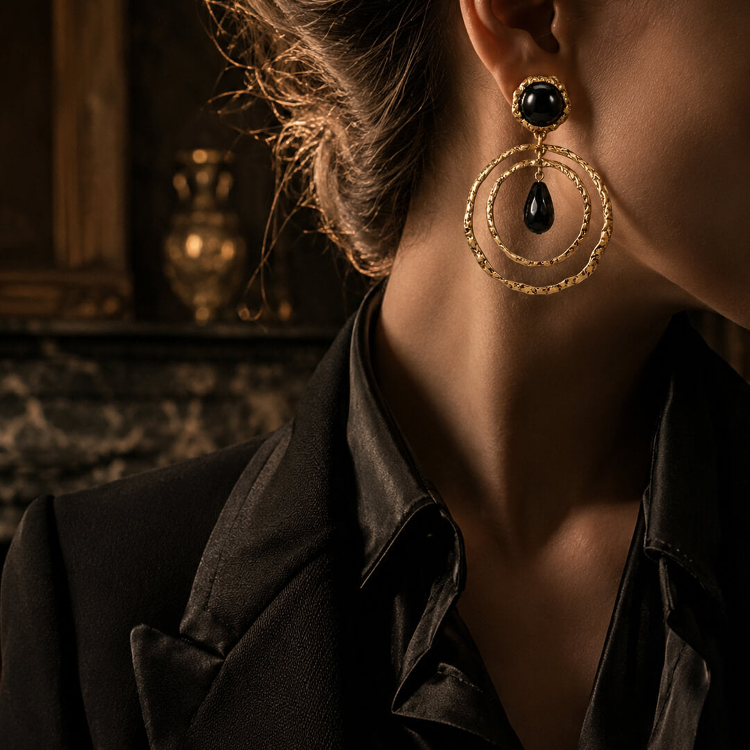Styling 1980s runway-inspired chunky gold drop earrings with a black blazer.