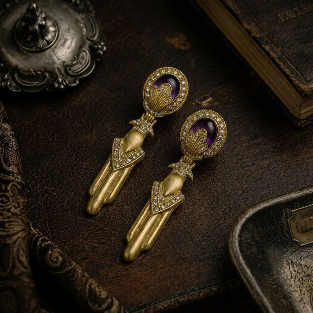 Detailed view of the antiqued gold-tone finish and geometric design on 1980s inspired drop earrings.