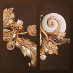 Close-up macro details of faux pearl, black crystals, and shell texture on a gold snail brooch.