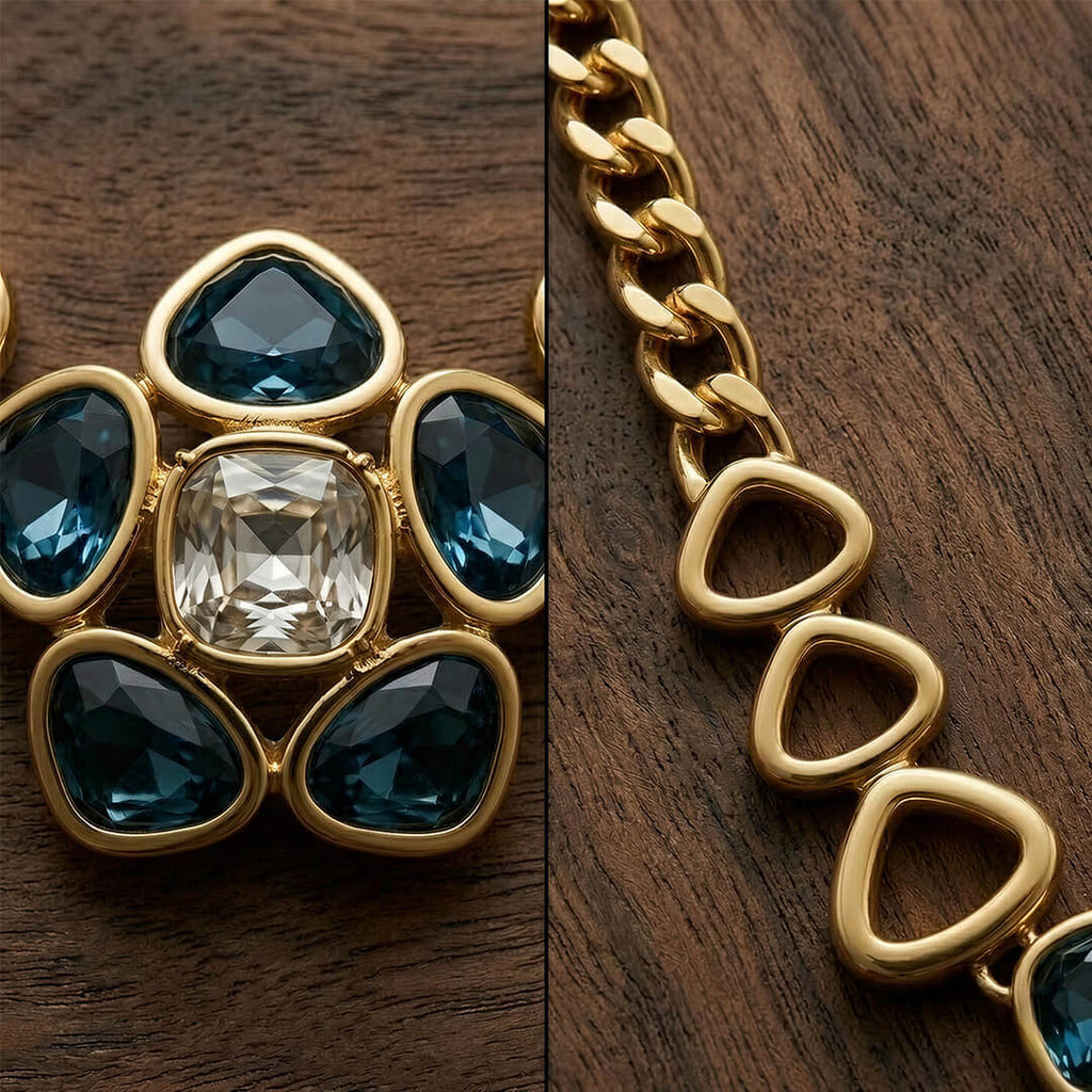 Alt Text: Macro shot showing the intricate details of a vintage-inspired jewelry piece, featuring a large clear central crystal surrounded by azure blue stones and a heavy gold-tone chain.
