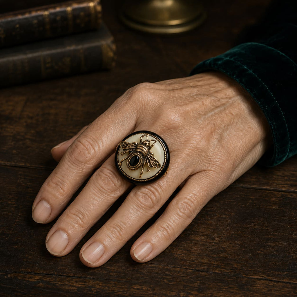 Woman wearing a Vintage-Inspired bee cameo statement ring with a black and ivory round face.