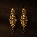 Front view of Duskcast Victorian gold filigree drop earrings with black teardrops.