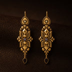 Front view of Duskcast Victorian gold filigree drop earrings with black teardrops.