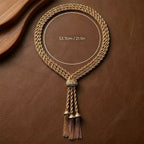 Sizing and dimensions of the vintage-inspired gold-tone braided tassel necklace. Heavyweight 1980s runway revival accessory.
