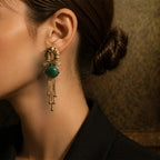 Model showcasing the drape of heavy gold snake chain fringe earrings