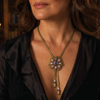 Woman wearing a Vintage-Inspired lavender floral lariat necklace with a black evening outfit.

第 2 张图