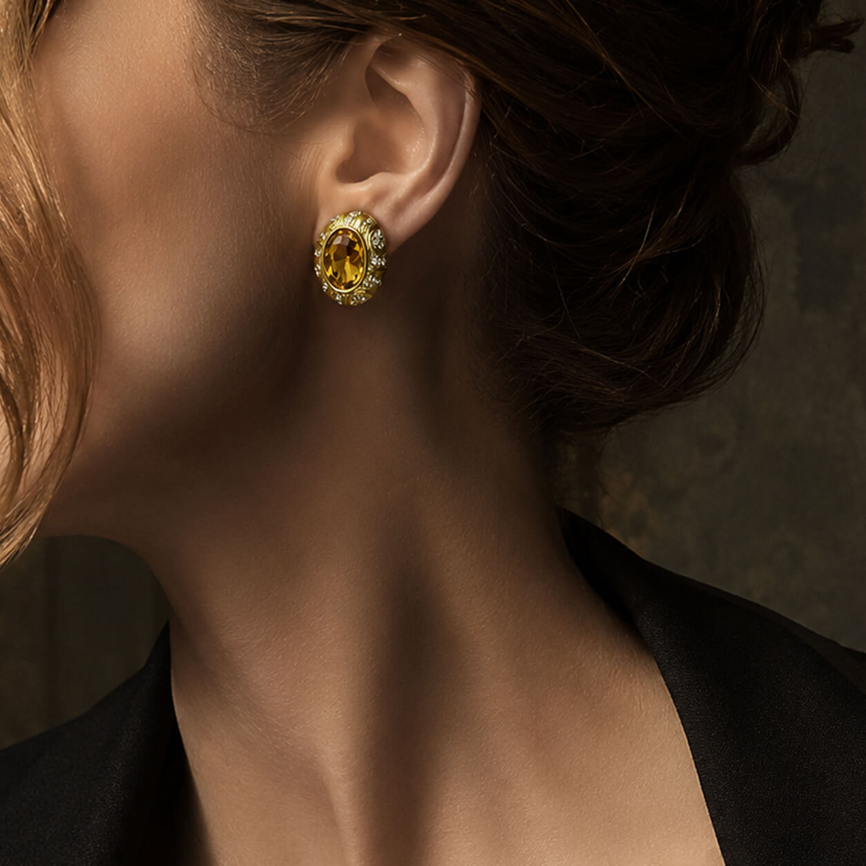 Close-up lookbook shot of a model wearing the Duskcast retro style oval honey citrine statement earring.