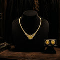 The complete Imperial Citrine necklace and earring set in 1980s aesthetic arranged on a black display bust.