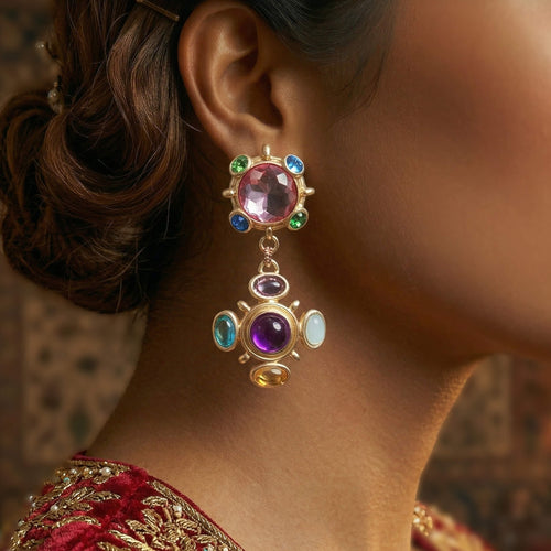 Woman wearing vintage chunky colorful statement clip-on earrings with a burgundy velvet dress.