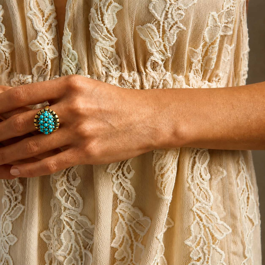 Woman wearing a Retro Style turquoise cluster statement ring with a cream lace outfit.