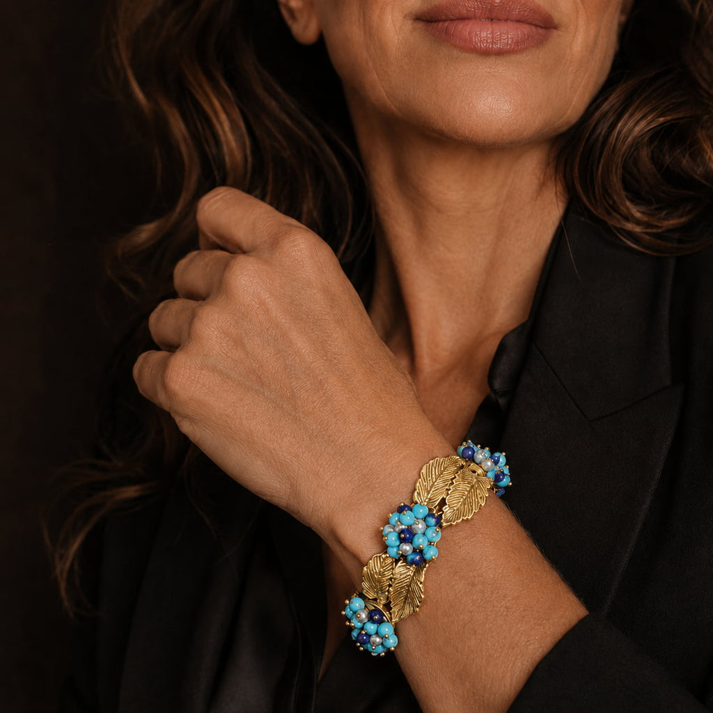 Woman wearing a Retro Style turquoise leaf statement bracelet with a black tailored blazer.