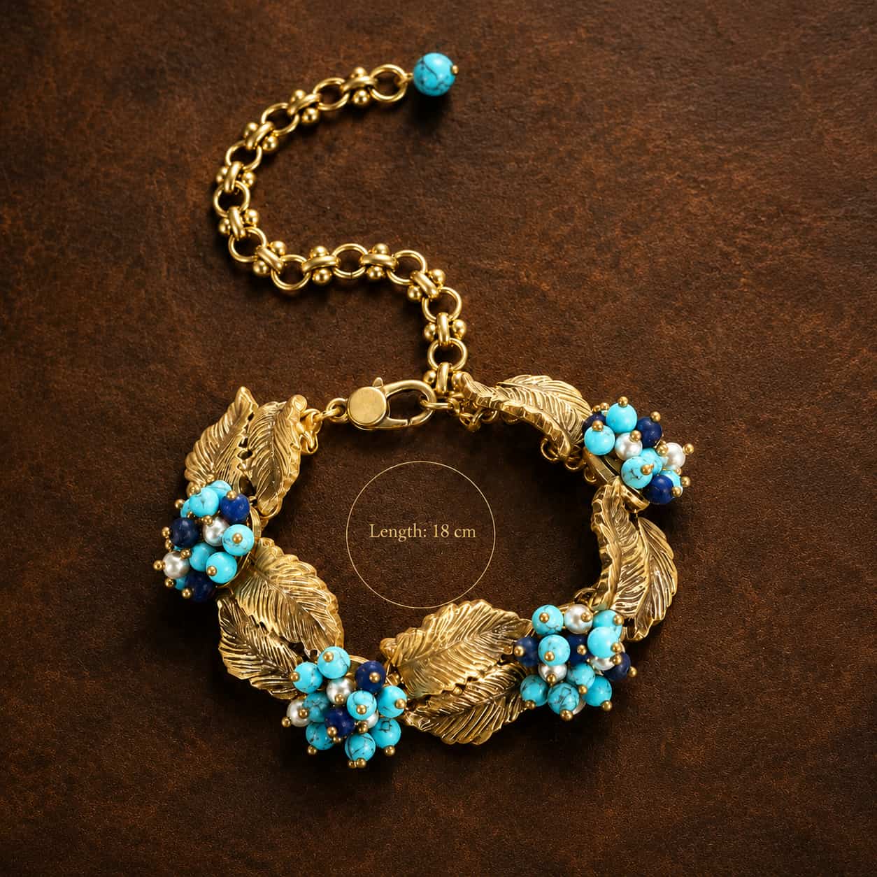 Vintage-Inspired turquoise leaf statement bracelet shown with an 18 cm length on a dark brown background.