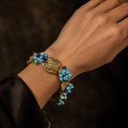 Close-up wrist view of a Retro Style turquoise leaf statement bracelet with gold-tone details.