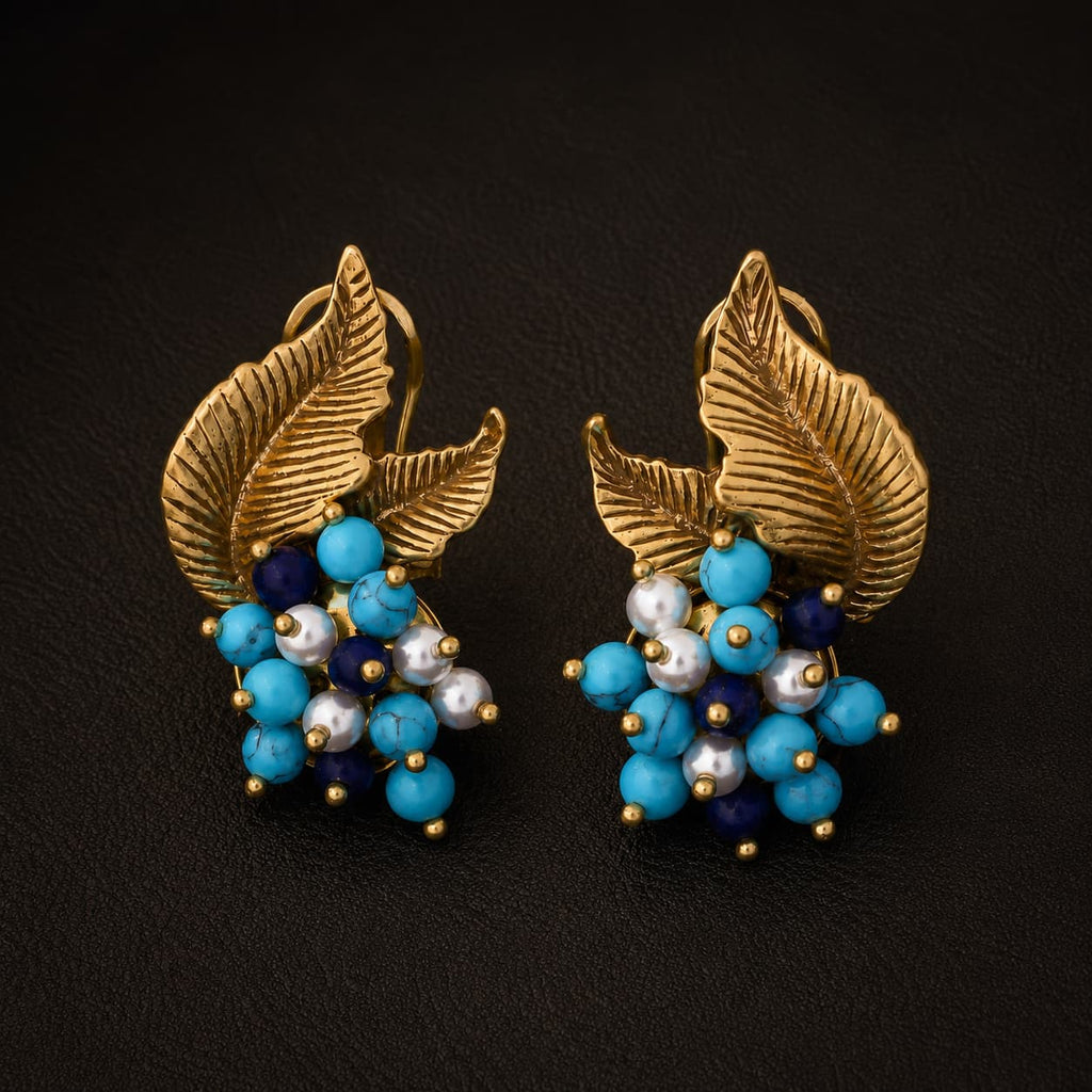 Vintage-Inspired turquoise leaf statement earrings with gold-tone leaves and clustered blue beads.