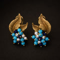 Vintage-Inspired turquoise leaf statement earrings with gold-tone leaves and clustered blue beads.