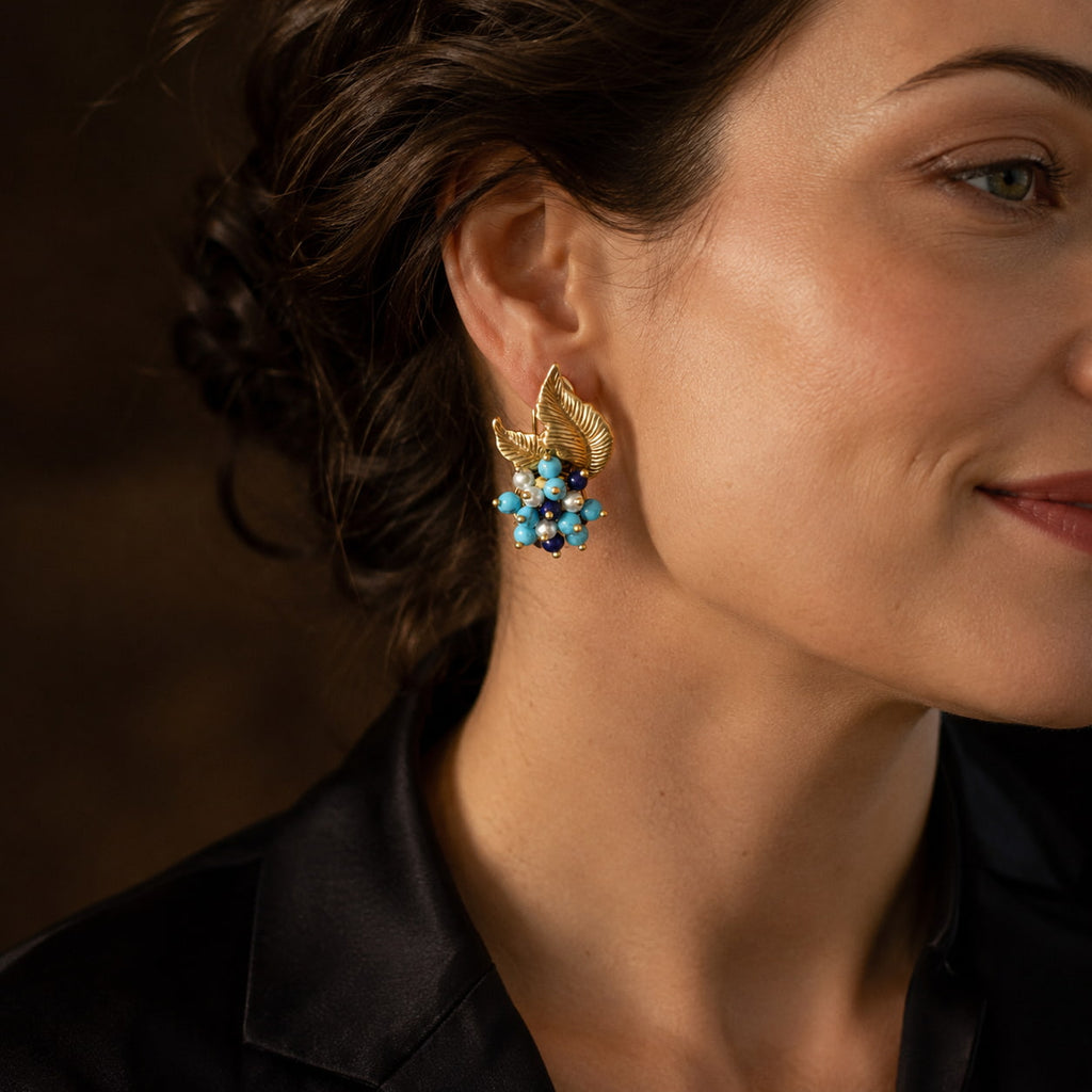 Close-up model view of Retro Style turquoise leaf earrings with gold-tone and pearl-like details.