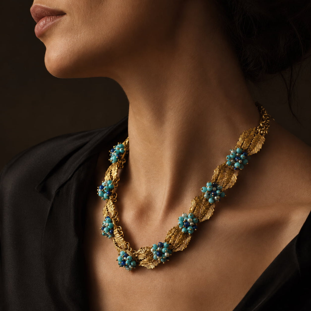 Model wearing a Vintage-Inspired turquoise leaf statement necklace with a black evening outfit.