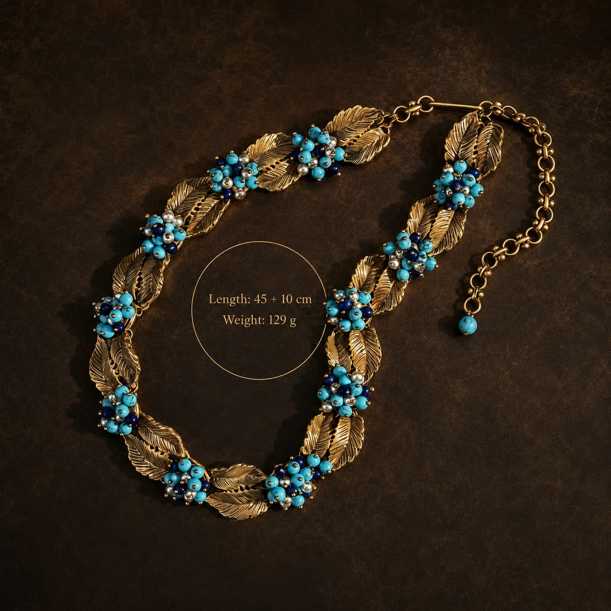 Size view of a Vintage-Inspired turquoise leaf statement necklace showing a 45 plus 10 cm length and 129 g weight.
