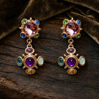 Vintage gold tone Byzantine cross clip-on earrings featuring faceted pink and cabochon purple gemstones.
