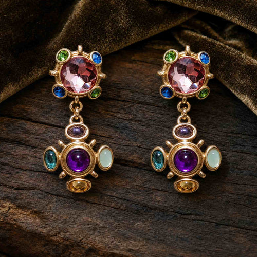 Vintage gold tone Byzantine cross clip-on earrings featuring faceted pink and cabochon purple gemstones.