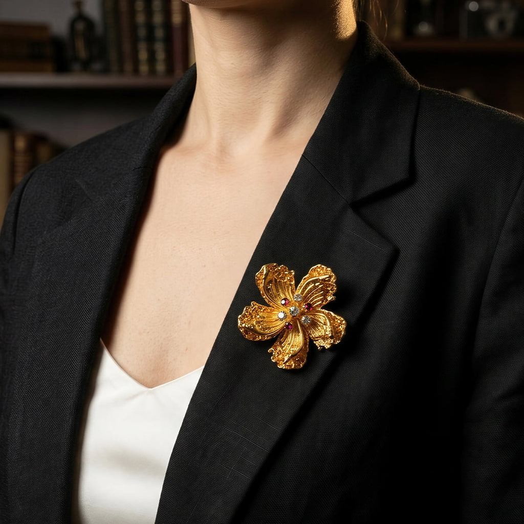 Vintage-Inspired gold alloy floral brooch with zircon accents styled on black blazer
