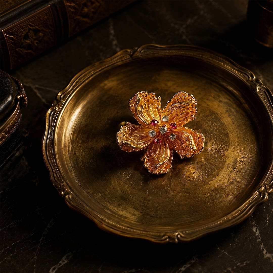 Vintage-Inspired gold alloy floral brooch with zircon accents on vintage-style tray