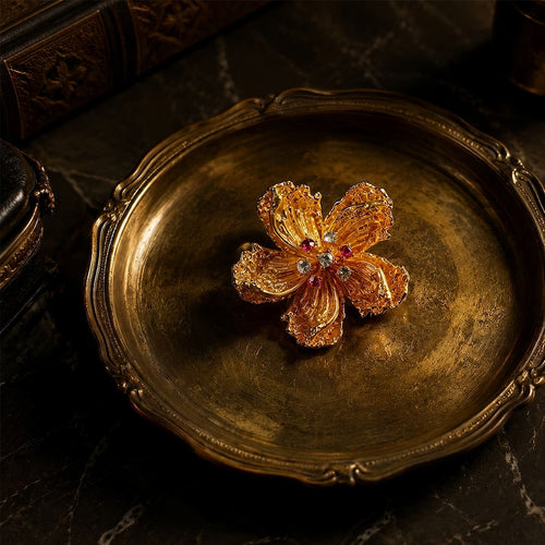 Vintage-Inspired gold alloy floral brooch with zircon accents on vintage-style tray