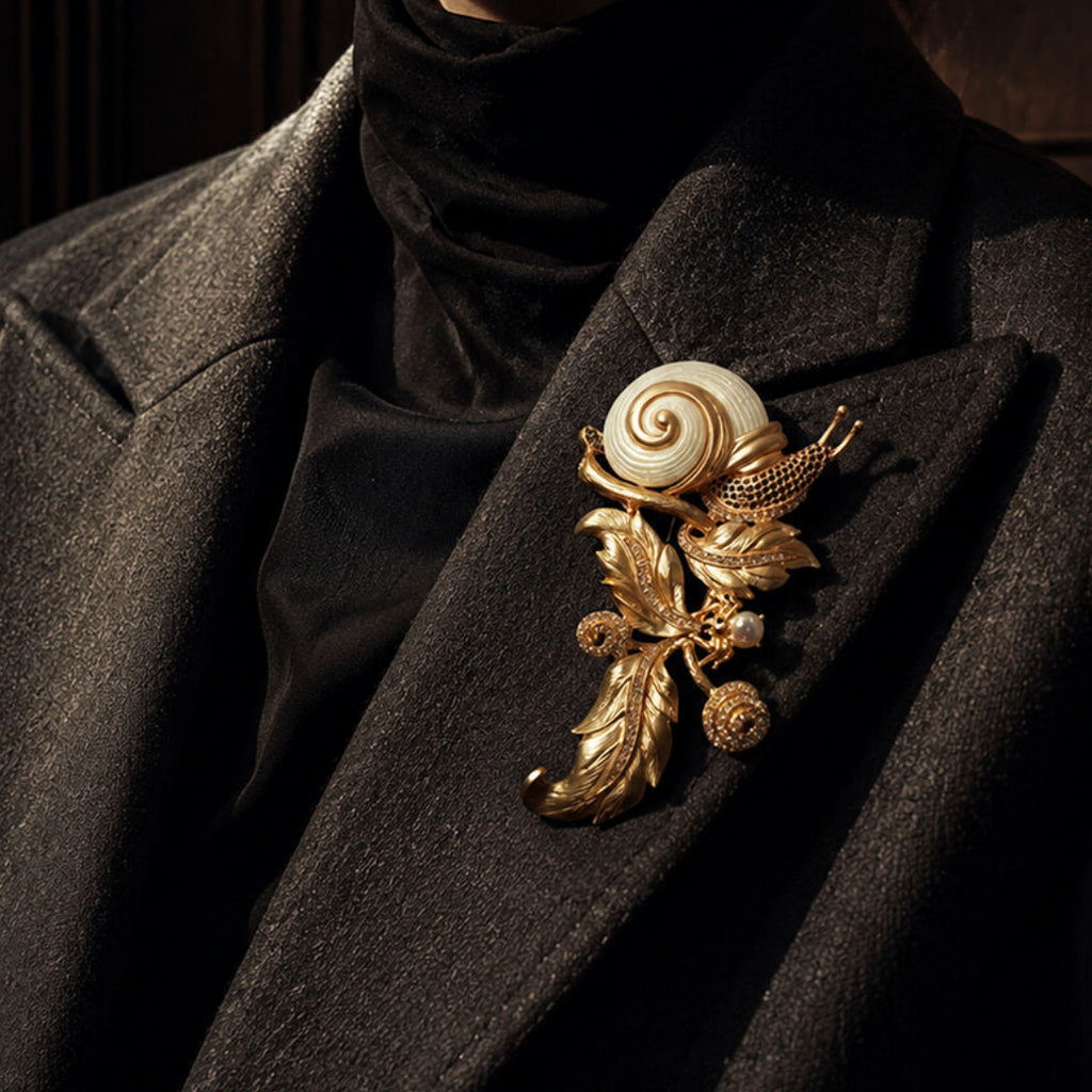 Woman wearing an oversized vintage-inspired gold snail brooch on a dark coat, Old Money aesthetic.